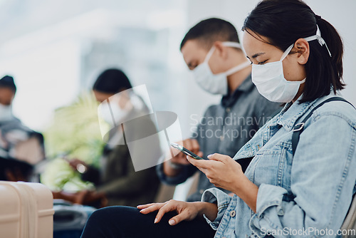 Image of Female tourist on phone traveling during covid at airport waiting for departure, wearing a mask for protection. For hygiene and healthcare security, follow corona virus social distance regulations.