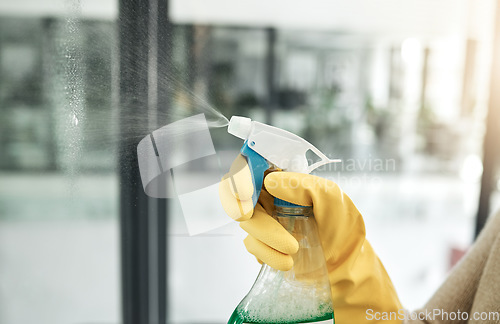 Image of Clean, wash and day chores at home with a household hygiene spray bottle for windows inside. Closeup of cleaning job, washing and working hand with gloves spraying glass cleaner with care indoors