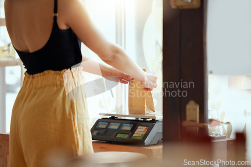 Image of Employee, entrepreneur or business owner weighing or scaling a product to be sold, bought or delivered. Staff, retail store or grocery worker getting weight of consumables or shopping supplies