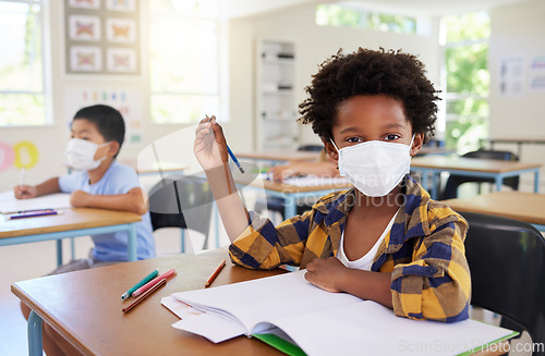 Image of Child or student in class during covid, wearing a mask for hygiene and protection from coronavirus flu. Portrait kindergarten, preschool or elementary school boy sitting in a classroom ready to learn