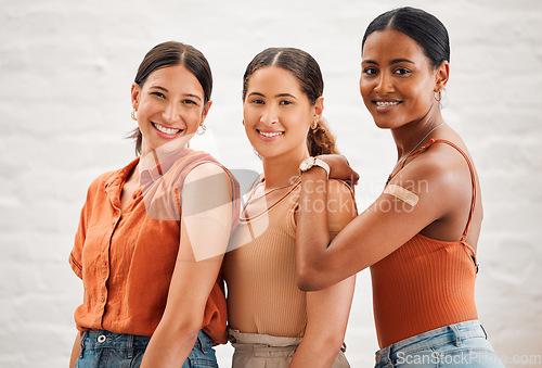 Image of Covid vaccination or flu shot inside of girl friends, female friendship and teenagers smiling. Portrait of a happy and diverse friend group standing and practicing good health habits together