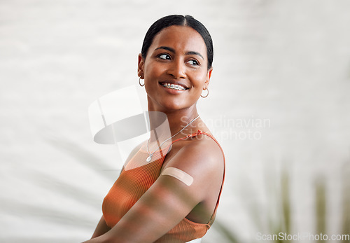 Image of Covid vaccine, safety and health with plaster after vaccination for business protocol or policy and protection against the virus. Smiling female worker showing her arm after injection