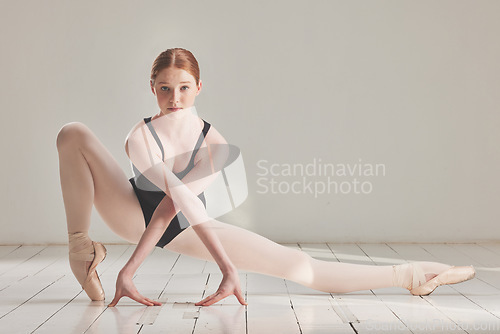 Image of Ballet dancer, ballerina and artist posing in beautiful, elegant or classical choreography in dance studio. Portrait of serious professional, performer and dancer practicing, performing or rehearsing