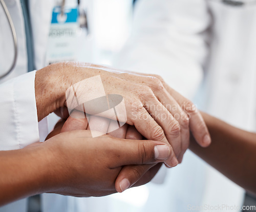 Image of Doctor, holding a patients hands and comforting them after the loss of a loved one at a hospital. Medical consultant, reassuring sick person after a cancer diagnosis and giving support or treatment.