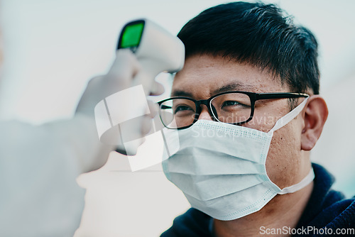 Image of Covid temperature scanning a man head or healthcare worker doing protocol, routine checkup of patient arriving at the airport or border. Traveling refugee or foreign man with face mask in quarantine