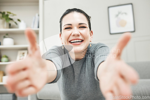 Image of Happy, smiling and laughing woman reaching out her arms for a hug, embrace or holding while relaxing alone at home. Portrait of a relaxed, content and cheerful female giving embrace and being playful