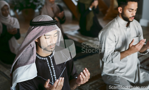 Image of Religion, Arabic and Muslim family praying, kneeling and worshipping together in an Islamic Mosque to honor and God. A religious, traditional and spiritual group of holy men on Eid Ramadan on carpets