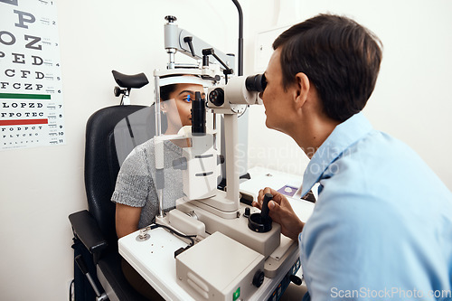 Image of Eye and vision test, exam or screening with an optometrist, optician or ophthalmologist and a patient using an ophthalmoscope. Testing and checking eyesight for prescription glasses or contact lenses