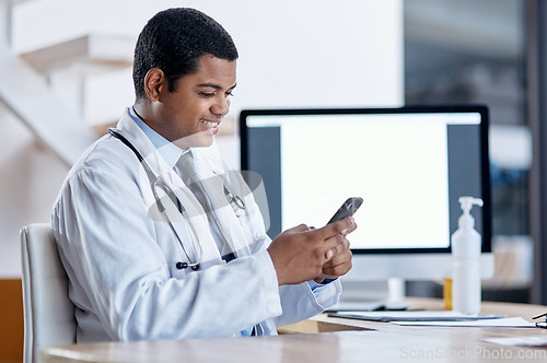 Image of Doctor consulting with an online patient on video call on a phone, doing telemedicine and listening during a medical appointment. Happy, smiling professional worker reading email and checking planner