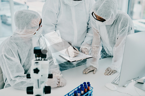 Image of Team of scientists, pathologists and doctors in hazmat suits discussing forensic research and plans in a lab. Medical experts working on tests, experiments and drug trial to develop cure for disease