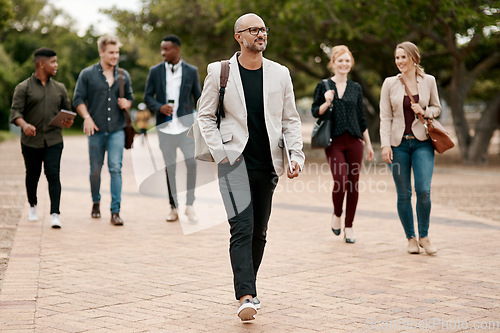 Image of Business travel, walking or commute for entrepreneurs, diverse colleagues or group leaders in city, town or downtown. Confident, motivated or assertive manager leading interns and commuting to work