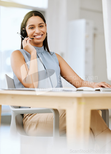 Image of Call center agent giving advice, helping clients with headset and networking on a desktop computer in an office at work. Portrait of a smiling customer service agent talking, discussing and planning