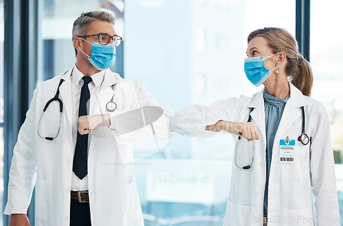 Image of Elbow greeting, doctors and medical healthcare workers with covid 19 virus safety masks in a hospital portrait. Life, emergency and wellness social distancing to stay safe. Employee ready for service