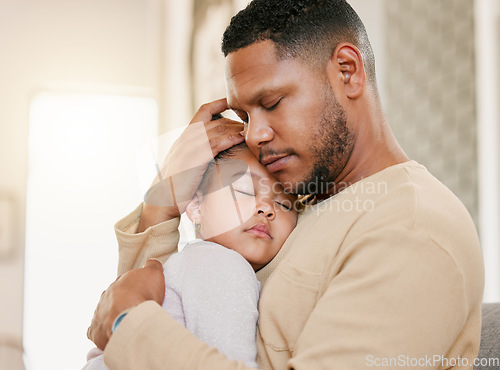 Image of Father hugging sleeping daughter, caring for sick child and family giving loving embrace at home. Girl child resting with parent, people napping together and recovering from sickness at house