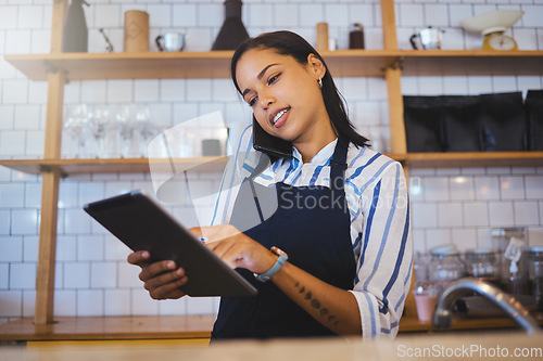 Image of Cafe manager, planning online customer orders and working on digital tablet with internet, phone call and sales in restaurant startup. Small business owner, woman entrepreneur and hospitality worker