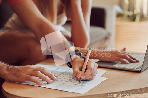 Image of Couple calculating budget, finance and tax while planning investment, loan and bills on writing paper and laptop at home. Managing household spending, savings and insurance report for online banking