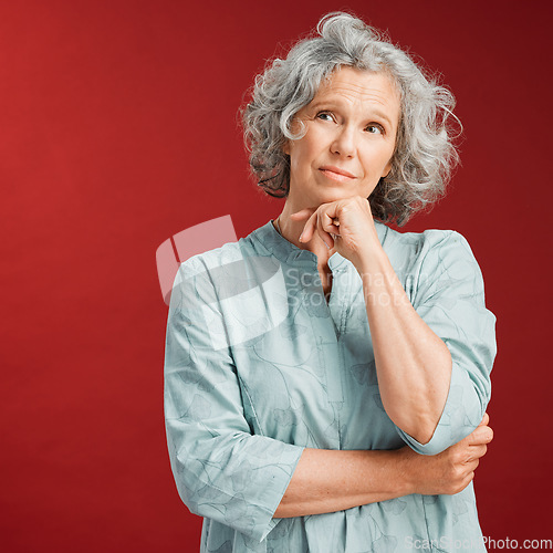 Image of Mature woman thinking, making a decision or choice about what to wear with copy space. Confused senior caucasian female lost in her thoughts. Serious and uncertain retired lady choosing an option.