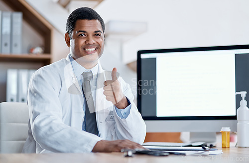 Image of Doctor, medical practitioner and healthcare worker showing thumbs up for FDA or drug approval in a hospital with blank screen copy space on a computer. GP pleased with clinic success in his office