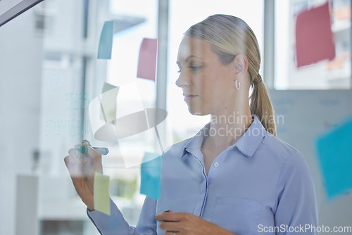 Image of Creative, schedule and planning of a female designer writing plans for tasks or ideas at the office. Woman in design working on a project plan or strategy to organize work and productivity.