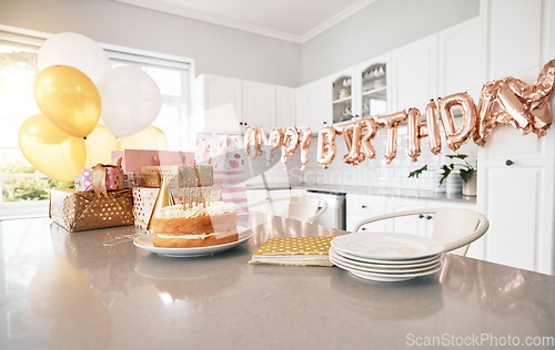 Image of Birthday, kitchen and cake stand with balloons for house party. Happy event, gifts and baked sweet goods for guests to eat. Decorations, special celebration and beautiful table of presents