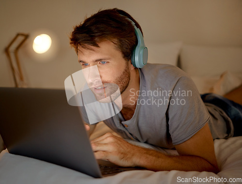 Image of Online, laptop and late night stream or work in the bedroom. Man using internet on pc to watch series, esports or gaming to relax. Stress management and entertainment with online technology at home.