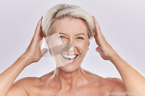 Image of Mature, portrait and woman touching hair against studio background with happy face copy space. Wellness woman for skincare, beauty cosmetics or healthy body supplements for anti ageing.