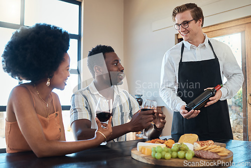 Image of Hospitality industry, restaurant service and waiter showing wine to couple on romantic date, talking and looking happy. Lovers enjoying conversation with sommelier and celebrating their relationship