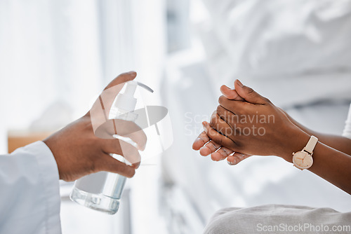 Image of Doctor giving patient hand sanitizer for covid protection, hygiene and protocol in hospital or clinic. Healthcare safety, flu germs and cleaning hands to prevent sick, bacteria virus and health risk