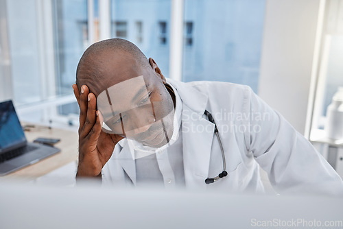 Image of Stress, anxiety and sad doctor at work on computer, sick and headache in a hospital or clinic. Medical professional or healthcare worker in depression, burnout and working and thinking about health.