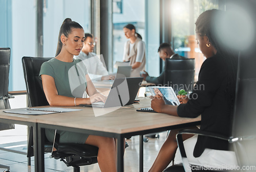 Image of Office corporate business female employees, coworkers and team working online with digital electronics. Diverse advertising and social media marketing company or agency staff busy with client work