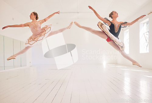 Image of Jumping team of female ballerinas, leaping ballet girls or performers in traditional tutu dress costume in the studio. Young, active and fit professional dancers dancing in balloon mid air pose.