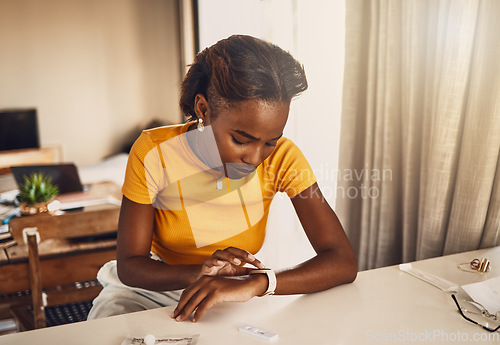 Image of Young, worried and stressed black woman waiting for the results of covid test. African American woman looking at the time on a smart watch and anxious or fearful about her medical and health status