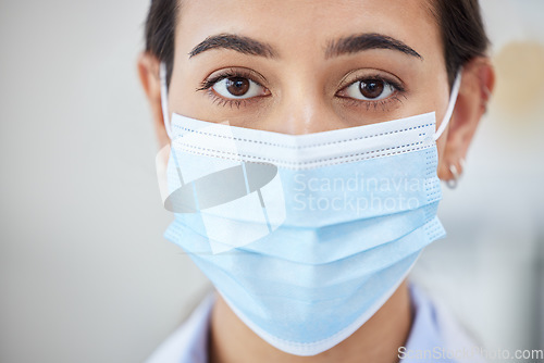 Image of Covid doctor with face mask for safety, medicine and hygiene while working in a medical hospital or clinic. Portrait of woman nurse, healthcare expert and professional worker in corona virus pandemic