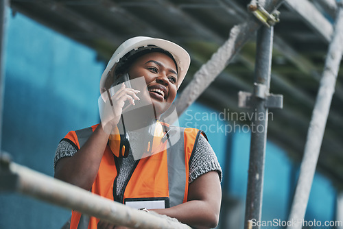 Image of Construction manager, contractor and engineer talking on a phone while planning logistics at a building site in town. Happy, smiling and cheerful young female architect, supervisor and city planner