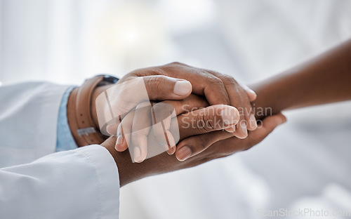 Image of Support, trust and hospital care with a doctor and patient holding hands, sharing bad news of a cancer diagnosis. Kind doctor offering a loving gesture to a sick person during a health crisis