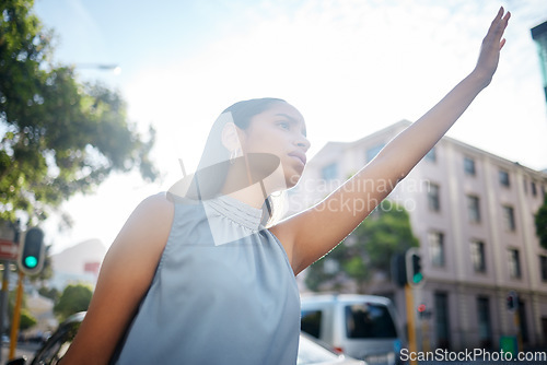 Image of Travel with taxi, cab or uber in a city for business woman to commute to work, airport or hotel with transport. Young female worker stretching hand in town street, road or sidewalk for trip outside
