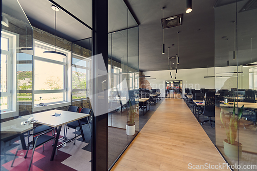 Image of In a setting of modern, glass-walled business startup offices, the open, airy workspace reflects a contemporary and innovative ambiance, promising a dynamic environment for entrepreneurial growth