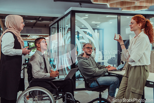 Image of Young group of business people brainstorming together in a startup space, discussing business projects, investments, and solving challenges.