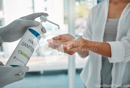 Image of Sanitizer or sanitizing woman cleaning her hands to prevent the spread of covid at the airport. Closeup of a female using antibacterial disinfectant for coronavirus protection in a modern building