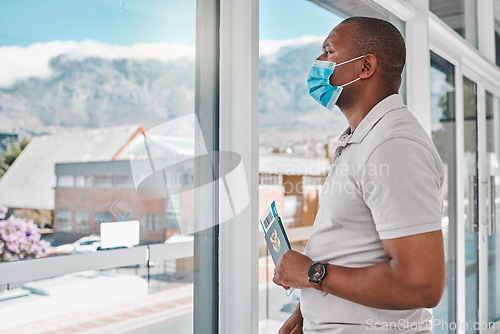 Image of Man at airport with covid passport and mask for safety from a virus waiting for flight during international travel. Tourist standing at window to board airplane for vacation during corona pandemic