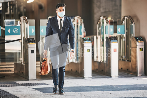 Image of Covid, health and safety on public transport, a businessman walking in a bus or train station in a business suit and face mask. Career, travel and an office worker on his morning journey in the city.