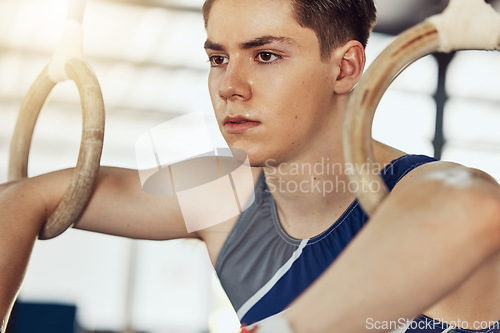 Image of Sport, exercise and training rings for a gymnastics athlete or gymnast in a gym. Fit and active sportsman doing fitness, wellness and sports workout to train his strength and flexibility