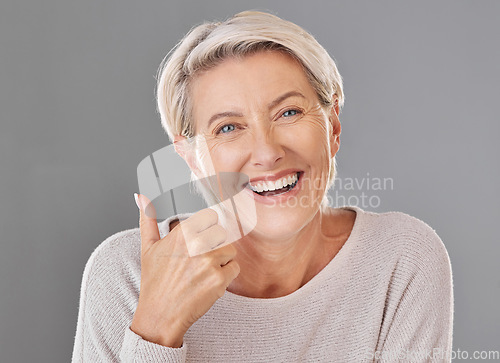 Image of Skincare, wellness and thumbs up by happy mature woman smiling showing winning hand gesture against studio background. Senior support and recommend cosmetic surgery, treatment or product for wrinkles