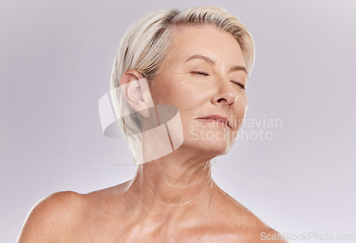 Image of Beauty, skincare and face of a senior woman posing with closed eyes and topless against grey studio background. Happy old, elderly or mature female with glowing skin due to cosmetic self care