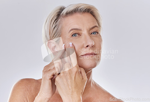 Image of Acne or pimple popping senior woman while doing a skincare beauty treatment for healthy and clear skin. Portrait of happy old, mature or elderly female squeezing a spot on her face