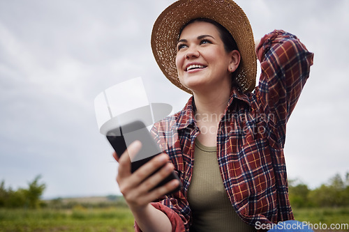 Image of Agriculture, nature and 5g connection by farmer texting on a phone, reading social media while relaxing outdoors. Happy worker browsing the internet for natural sustainability tips, products online