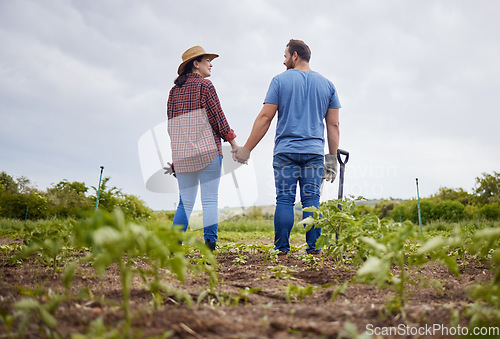 Image of Farmer couple happy about agriculture growth with vegetable crops or plants in aorganic or sustainability farm or garden. Man and woman in nature love and enjoying outdoor and having fun together