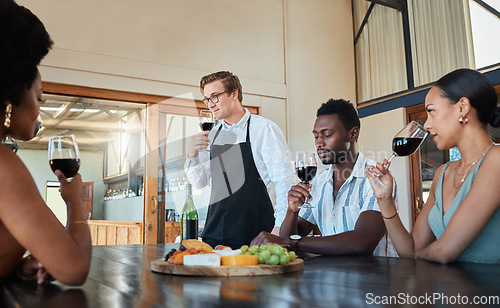 Image of Hospitality, luxury and wine tasting at a restaurant with a professional sommelier teaching how to enjoy red wine. Diverse group having fun, celebrating their friendship with getaway and fine dining