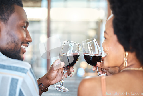 Image of Couple giving cheers, toast and celebrate with wine glass, champagne and alcohol drinks on a romantic date together. Love, relax and smile black people in celebration of happy marriage relationship