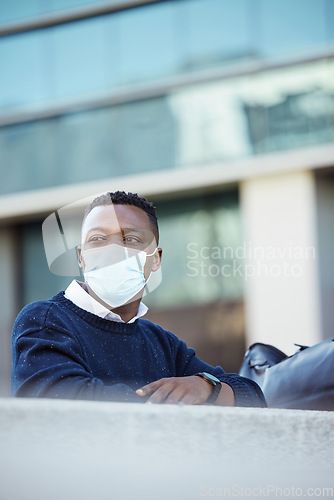 Image of Covid, travel restrictions and immigration with a man in a mask waiting outside of the airport in the day. Flight delay and ban due to safety, control and regulations in the corona virus pandemic